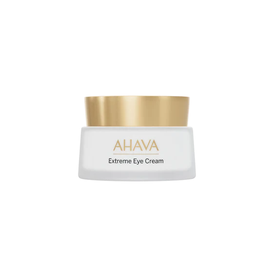 Jar of AHAVA Extreme Firming Eye Cream with frosted glass, dark lid, and label visible on a neutral background